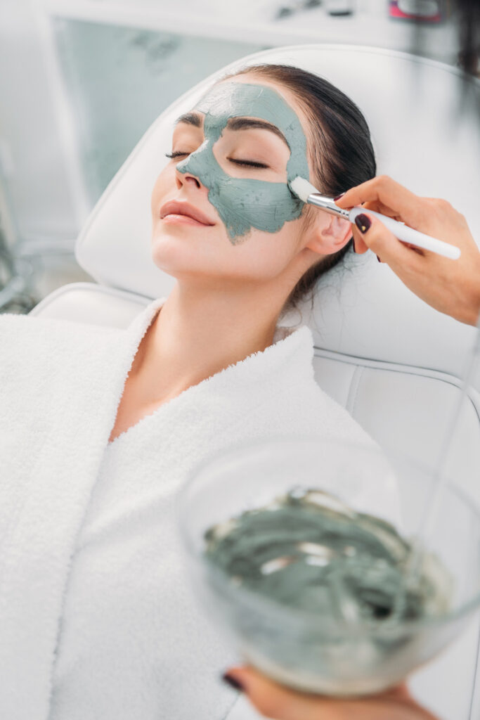 Woman receiving facial treatment while in a robe