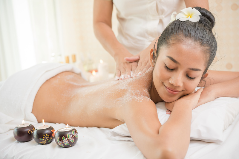 Woman having exfoliation treatment in spa